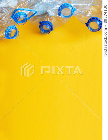 a lot of plastic empty rumpled used bottles on a yellow background. waste and pollution concept 89574130
