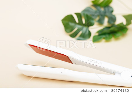 infrared professional iron tool for keratin hair straightening and recovery on a beige background 89574180