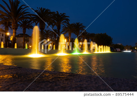 Beautiful colored fountain in the night city Beautiful colored fountain in the night city 89575444