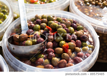 Pickled olives of different varieties at the bazaar. Pickled olives of different varieties at the bazaar. 89575485