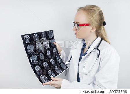 Epileptologist examines patient MRI and electroencephalogram. Concept treating epilepsy and helping people who suffer from this disease. Neurologist at work. Pathology of the brain. Seizure activity Epileptologist examines patient MRI and electroencephalogram. Concept treating epilepsy and helping people who suffer from this disease. Neurologist at work. Pathology of the brain. Seizure activity 89575768