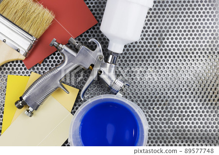 paint spray gun at work at the workplace in the workshop. 89577748