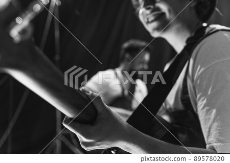 Repetition of rock music band at music studio. Cropped image of electric and acoustic guitar players at concert. Rehearsal base Concept of art, music, style 89578020