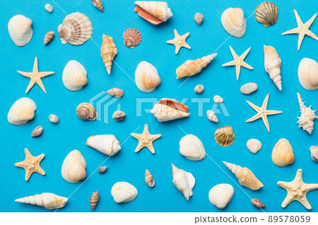 Summer time concept Flat lay composition with beautiful starfish and sea shells on colored table, top view 89578059