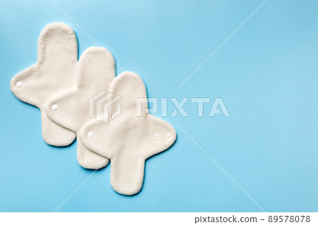 Eco-friendly reusable fabric women's pads. set of colorful bright reusable menstrual pads. zero waste woman periods concept top view with copy space Eco-friendly reusable fabric women's pads. set of colorful bright reusable menstrual pads. zero waste woman periods concept top view with copy space 89578078