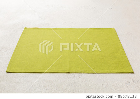 Perspective view of green tablecloth for food on cement background. Empty space for your design 89578138