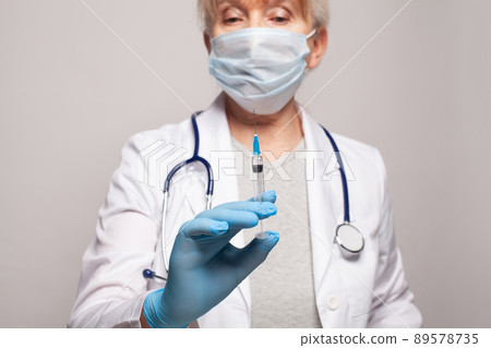 Nurse hands holding syringe closeup 89578735