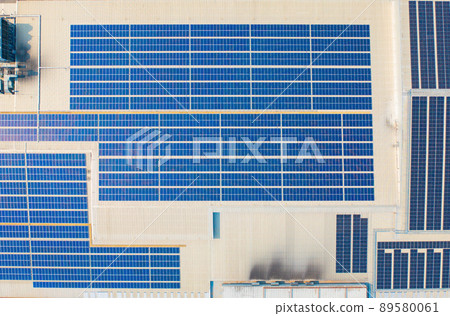 Aerial view of solar panels or solar cells on the roof of shopping mall building rooftop. Power plant, renewable clean energy source. Eco technology for electric power in industry. Aerial view of solar panels or solar cells on the roof of shopping mall building rooftop. Power plant, renewable clean energy source. Eco technology for electric power in industry. 89580061