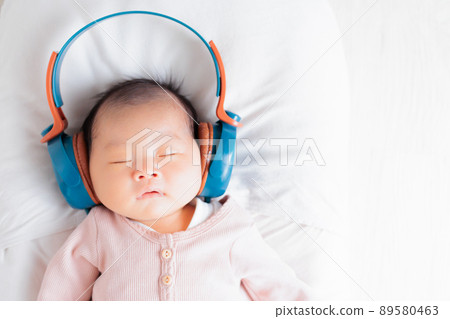 Baby image listening to music Newborn headphones Dancing facial expressions 89580463