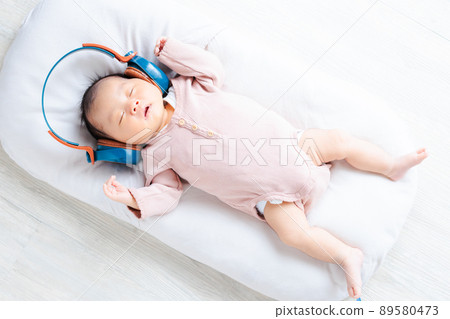 Baby image listening to music Newborn headphones Dancing facial expressions Baby image listening to music Newborn headphones Dancing facial expressions 89580473