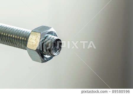 Stainless steel bolts and nuts on a white background. Bolt, washer and nut on a white background. Bolt on a white background. Bolt screw nut washer carving. Stainless steel bolts and nuts on a white background. Bolt, washer and nut on a white background. Bolt on a white background. Bolt screw nut washer carving. 89580596
