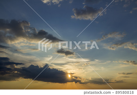 Panorama of sky at sunrise or sunset. Beautiful view of dark blue clouds lit by bright orange yellow sun on clear sky. Beauty and power of nature, meteorology and climate changing concept. Panorama of sky at sunrise or sunset. Beautiful view of dark blue clouds lit by bright orange yellow sun on clear sky. Beauty and power of nature, meteorology and climate changing concept. 89580818