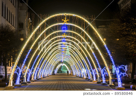 Night view of New Year or Christmas decorative arches with bright lights during winter holidays in Ivano-Frankivsk city, Ukraine. Night view of New Year or Christmas decorative arches with bright lights during winter holidays in Ivano-Frankivsk city, Ukraine. 89580846