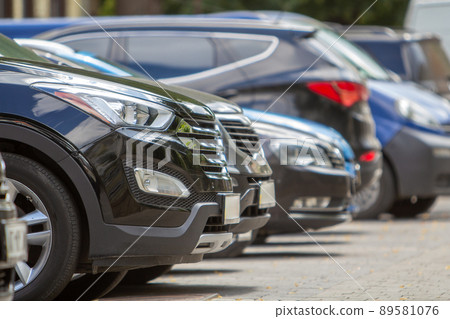 Kyiv, Ukraine - October 14, 2019: Row of cars parked near curb on the side of the street on a parking lot. 89581076