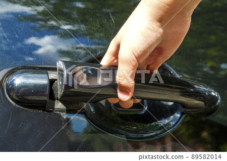 Close up of human child hand opening car door Close up of human child hand opening car door 89582014