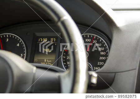 Close up interior view of modern luxurious black car. Dashboard, steering wheel, speedometer. Speed, comfort and luxury. Close up interior view of modern luxurious black car. Dashboard, steering wheel, speedometer. Speed, comfort and luxury. 89582075