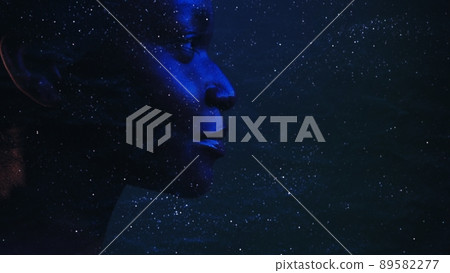 Human universe. Cosmic portrait. Dream consciousness. Neon blue closeup profile silhouette of mysterious woman face on dark night stardust wrinkled texture copy space background. 89582277