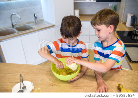 happy family funny kids are preparing the dough, bake cookies in the kitchen 89583654