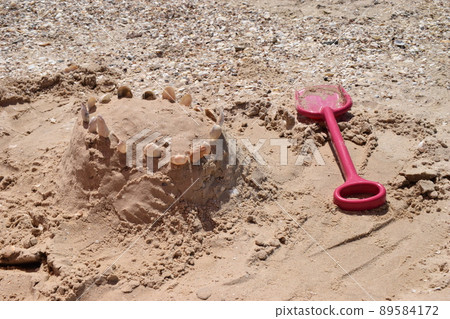 Plastic sandbox toys on the sand. kids toys on tropical sand beach. 89584172