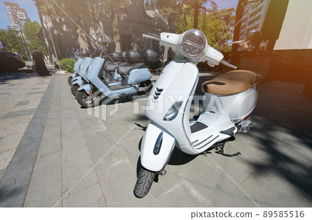 Moto scooters park in city street Moto scooters park in city street 89585516