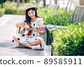 Asian woman playing guitar in the park, lifestyle and recreation concept. 89585911