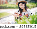 Asian woman playing guitar in the park, lifestyle and recreation concept. 89585915
