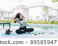 Happy asian woman stretching exercise and yoga workout in the morning at home 89585947