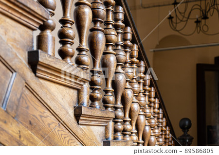 Wooden old decorative balusters, Ancient wooden stairs. decorative railings carved from wood Wooden old decorative balusters, Ancient wooden stairs. decorative railings carved from wood 89586805