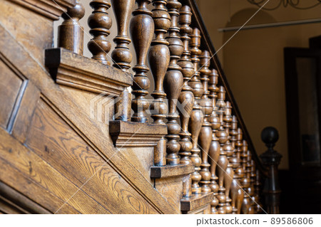 Wooden old decorative balusters, Ancient wooden stairs. decorative railings carved from wood Wooden old decorative balusters, Ancient wooden stairs. decorative railings carved from wood 89586806