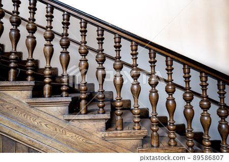 Wooden old decorative balusters, Ancient wooden stairs. decorative railings carved from wood Wooden old decorative balusters, Ancient wooden stairs. decorative railings carved from wood 89586807