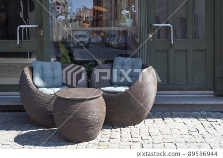 Empty chairs in outdoor cafe or restaurant. Tables and chairs at sidewalk cafe. Touristic settinfg or hotel entrance Empty chairs in outdoor cafe or restaurant. Tables and chairs at sidewalk cafe. Touristic settinfg or hotel entrance 89586944