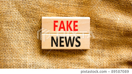 Fake news symbol. Wooden blocks with concept words Fake news on beautiful canvas background. Business media and fake news concept. Copy space. 89587089