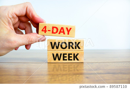 4-day work week symbol. Concept words 4-day work week on wooden blocks on beautiful white background. Businessman hand. Copy space. Business and 4-day work week and short workweek concept. 89587110