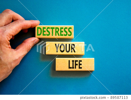 Destress your life symbol. Concept words Destress your life on wooden blocks. Doctor hand. Beautiful blue table blue background. Psychological business and destress your life concept. Copy space. 89587113