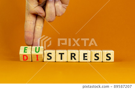 Eustress or distress symbol. Psychologist turns cubes and changes the concept word Eustress to Distress. Beautiful orange table orange background, copy space. Psychlogical distress eustress concept. Eustress or distress symbol. Psychologist turns cubes and changes the concept word Eustress to Distress. Beautiful orange table orange background, copy space. Psychlogical distress eustress concept. 89587207