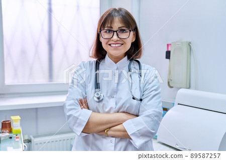 Portrait of confident smiling mature doctor woman looking at camera Portrait of confident smiling mature doctor woman looking at camera 89587257