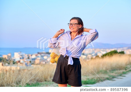 Happy woman enjoying summer sunset in mountain sea nature 89587396