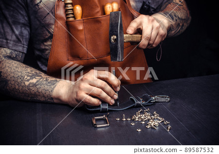 Artisan of leather produces leather goods 89587532