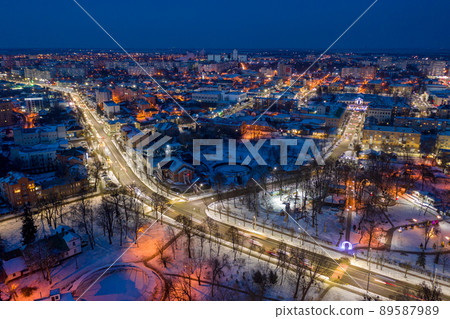 Beautiful evening top view of the city. Evening, night illumination in the city. Winter city in the snow. 89587989