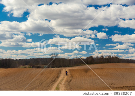 The man on bicycle is a photographer in the field The man on bicycle is a photographer in the field 89588207