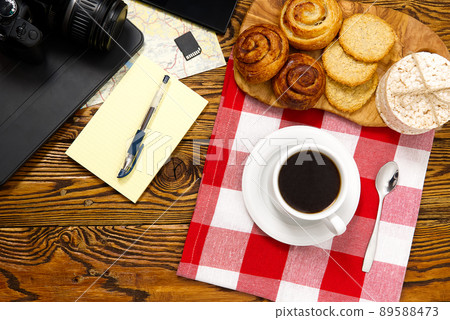 light breakfast, fresh pastries and coffee, on an old wooden table. tourist concept. Travel blogger breakfast building a route plan with cup of coffee light breakfast, fresh pastries and coffee, on an old wooden table. tourist concept. Travel blogger breakfast building a route plan with cup of coffee 89588473