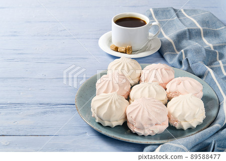 Good morning banner. Cup of coffee and homemade dessert zephyr, Zefir on light blue wood background. Top view. Food Photography with copy space Good morning banner. Cup of coffee and homemade dessert zephyr, Zefir on light blue wood background. Top view. Food Photography with copy space 89588477