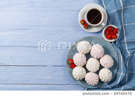 Good morning banner. Cup of coffee and homemade dessert zephyr, Zefir on light blue wood background. Top view. Food Photography with copy space Good morning banner. Cup of coffee and homemade dessert zephyr, Zefir on light blue wood background. Top view. Food Photography with copy space 89588478