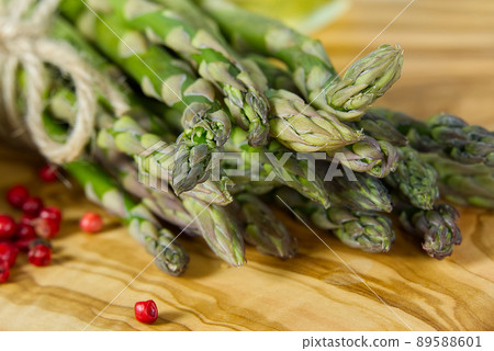 Fresh Young Asparagus closeup. Asparagus on wood board Fresh Young Asparagus closeup. Asparagus on wood board 89588601