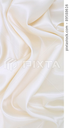 Smooth elegant white silk or satin luxury cloth texture as wedding background. Luxurious background design Smooth elegant white silk or satin luxury cloth texture as wedding background. Luxurious background design 89588616