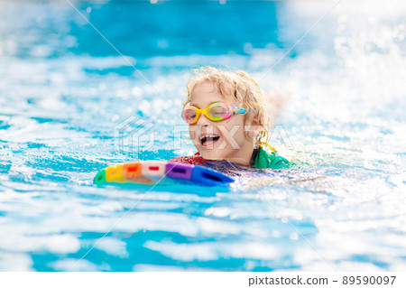 Child learning to swim. Kids in swimming pool. Child learning to swim. Kids in swimming pool. 89590097