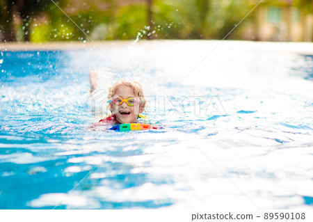 Child learning to swim. Kids in swimming pool. Child learning to swim. Kids in swimming pool. 89590108