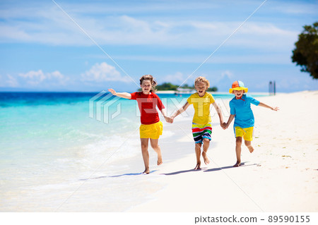 Kids playing on beach. Children play at sea. Kids playing on beach. Children play at sea. 89590155