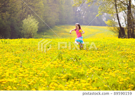 Kids play. Child in dandelion field. Summer flower 89590159