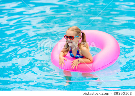 Child in swimming pool on toy ring. Kids swim. Child in swimming pool on toy ring. Kids swim. 89590168